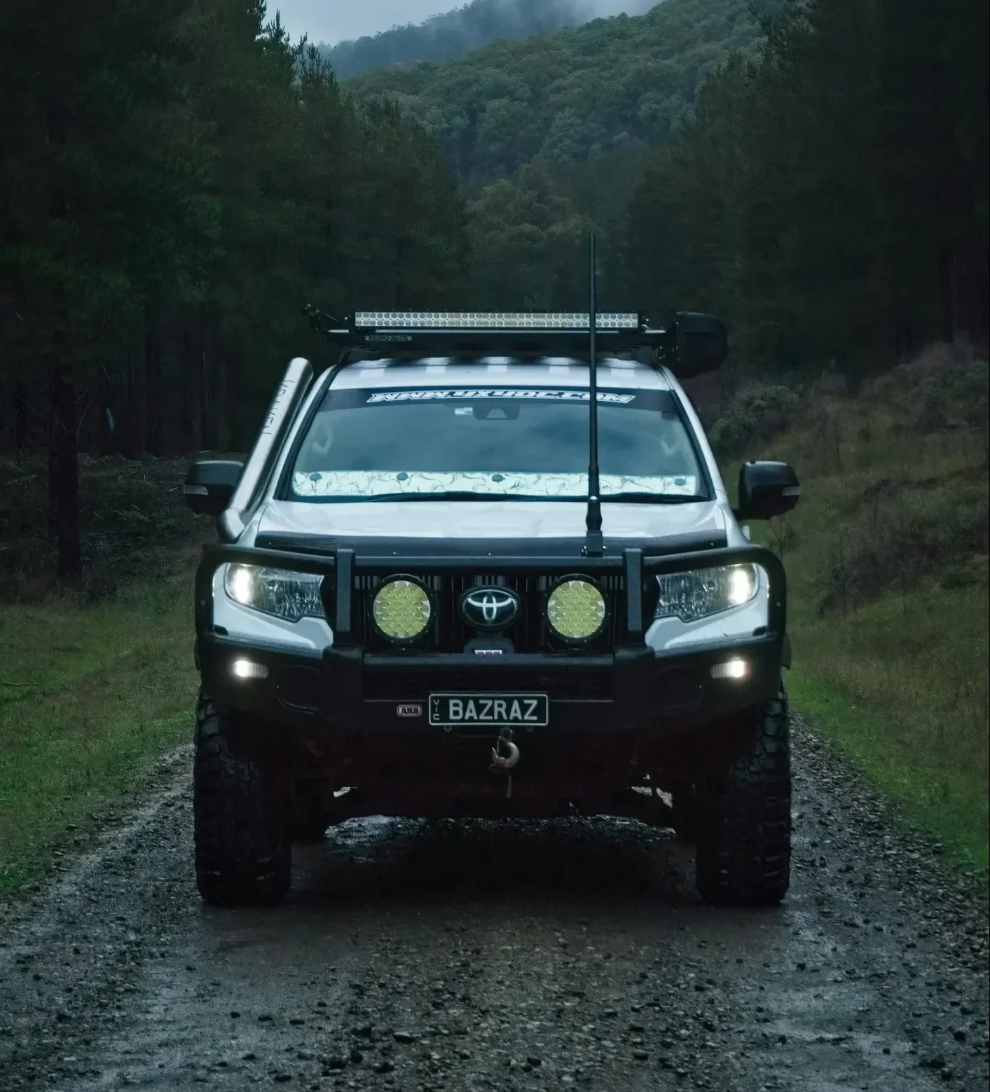 DIY vs Professional 4x4 Protection – What Works Best? 1 4x4 on a dirt road with a forest behind it.